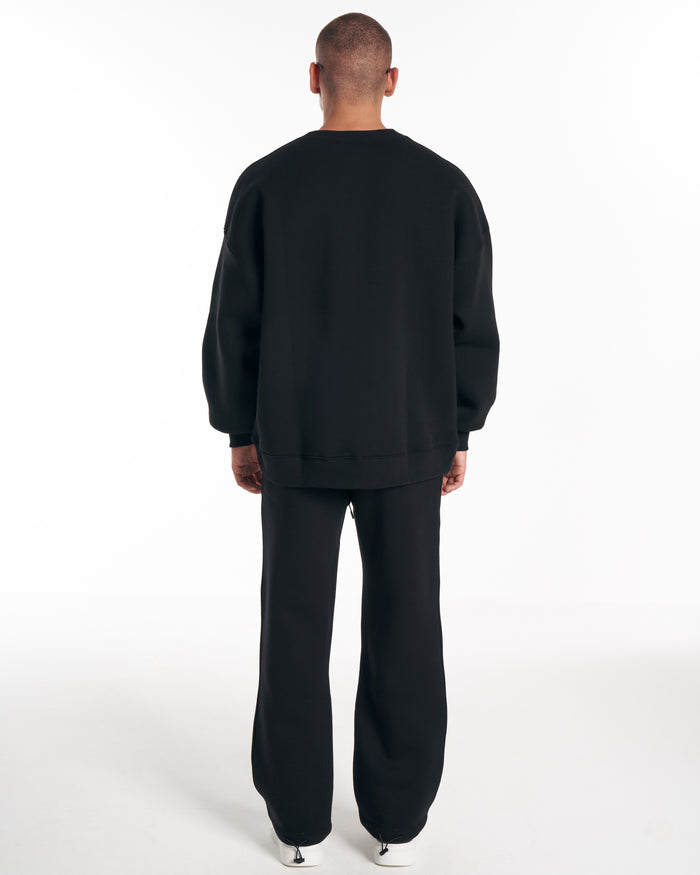 Martin Valen 1881 Designer 3D Embroidery black tracksuit, full rear view showing sweatshirt hem and shoes