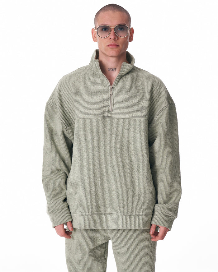 Martin Valen khaki high‑collar half‑zip tracksuit, full front view showing matching pants and white sneakers