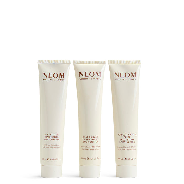 Three NEOM body butters on a white background