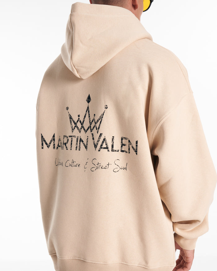 Martin Valen Regalia Crown oversized beige hoodie, close rear view of the hood and upper back showing partial black crown print