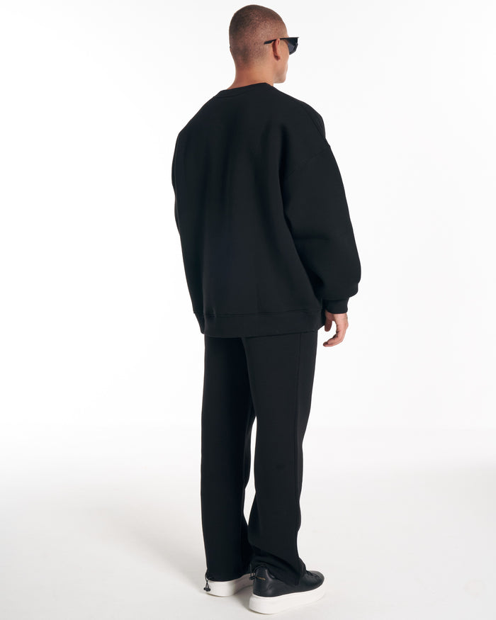 Martin Valen 1881 Designer 3D Embroidery oversized black sweatshirt, rear three-quarter view with sunglasses visible