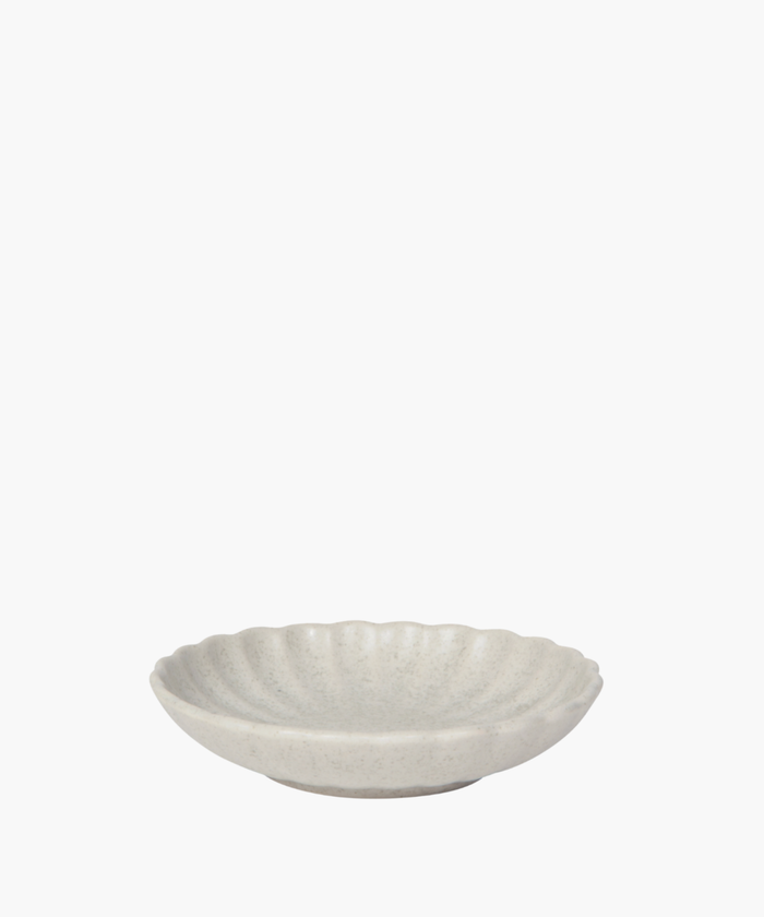 A round, cream-colored stoneware dish with a textured, scalloped edge, conveying a sense of elegance and simplicity against a plain white background. | SW Home
