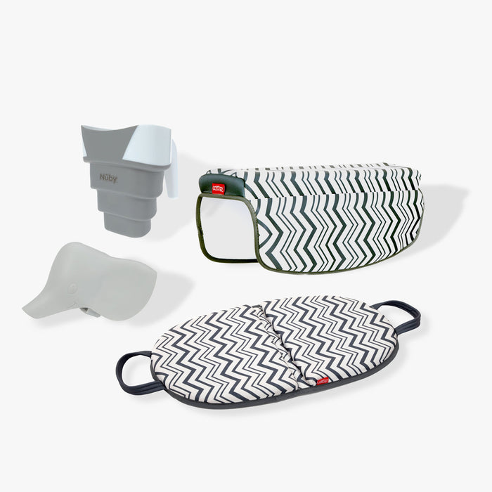 The Baby Bathtime Essentials Bundle features a safety spout guard, rinser cup, cushioned bath kneeler, and patterned arm rest—all in a chic black-and-white zigzag design.