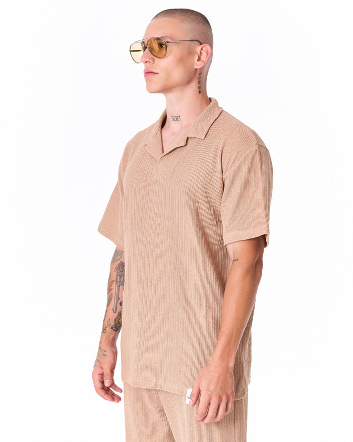 Martin Valen Breeze Fit men's beige tracksuit, standing view highlighting open-collar top and straight-leg trousers