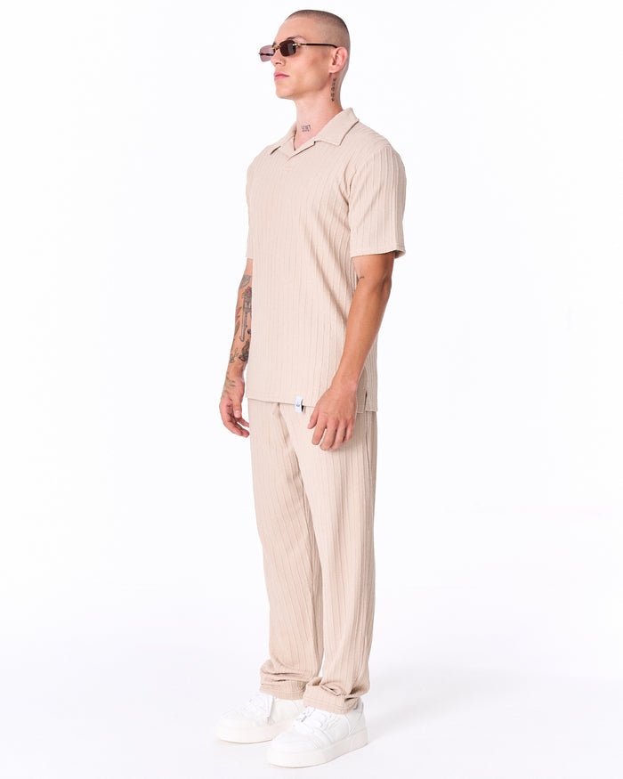Martin Valen Breeze Fit men's tracksuit in cream, side view of short‑sleeve ribbed top on model wearing sunglasses