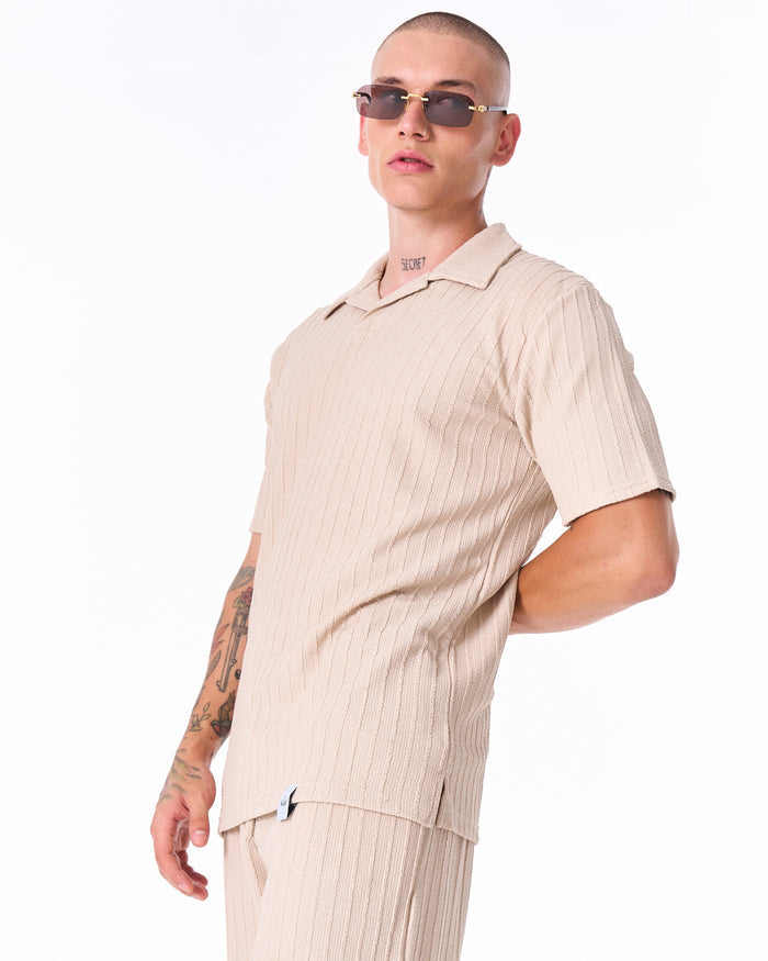 Martin Valen Breeze Fit men's tracksuit in cream, chest-up angled view showing textured polo collar