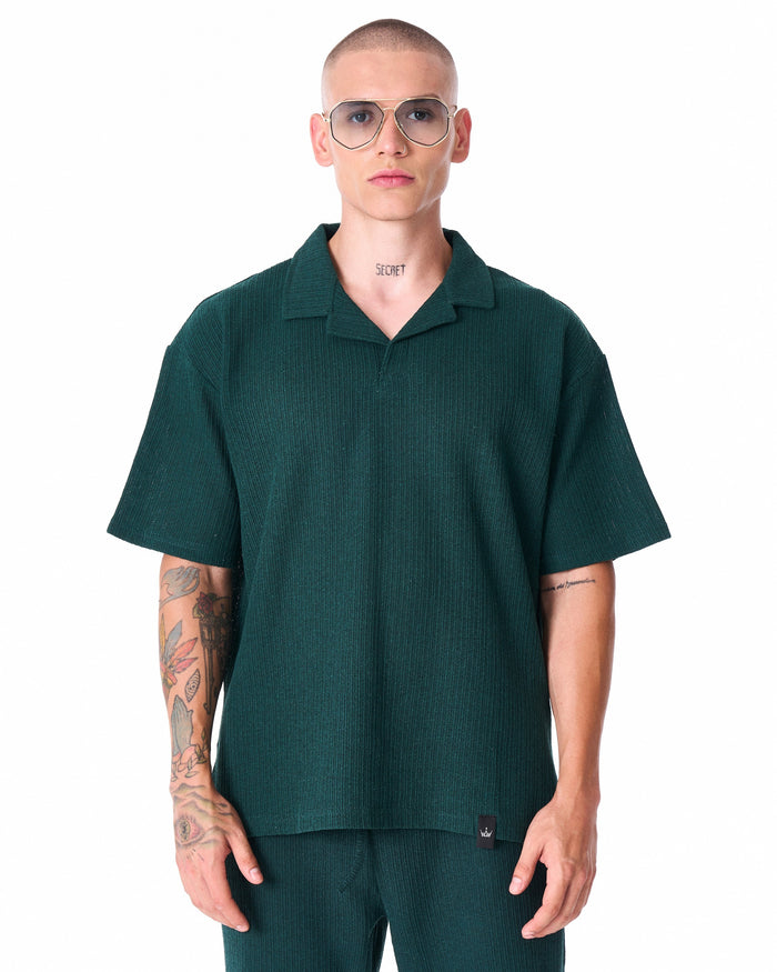 Martin Valen Breeze Fit men's tracksuit in dark green, mid-shot showing trousers and white sneakers