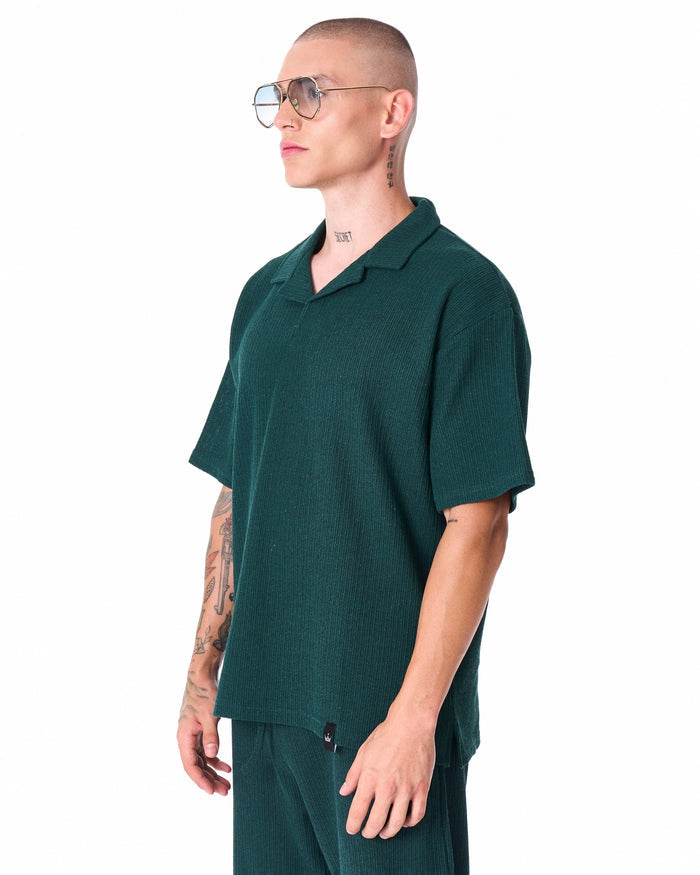 Martin Valen Breeze Fit men's tracksuit in dark green, upper-body close-up with aviator sunglasses