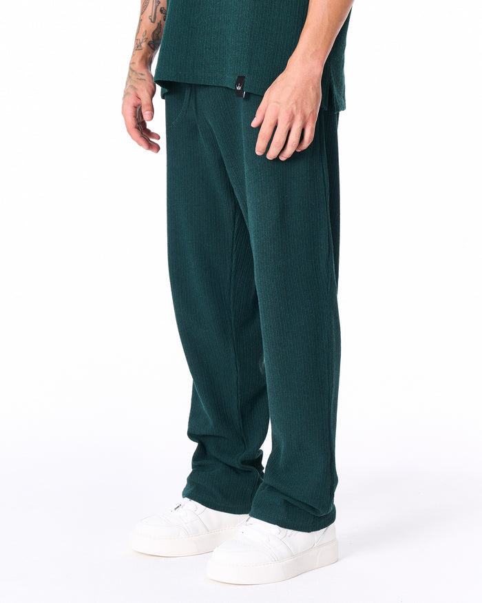 Martin Valen Breeze Fit men's tracksuit in dark green, side view showing short sleeves and woven tag