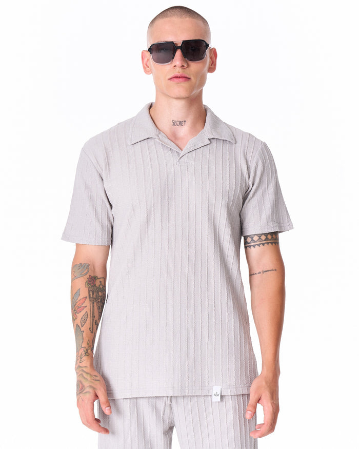 Martin Valen Breeze Fit men's gray tracksuit, close-up of chest showing short sleeves and model wearing sunglasses