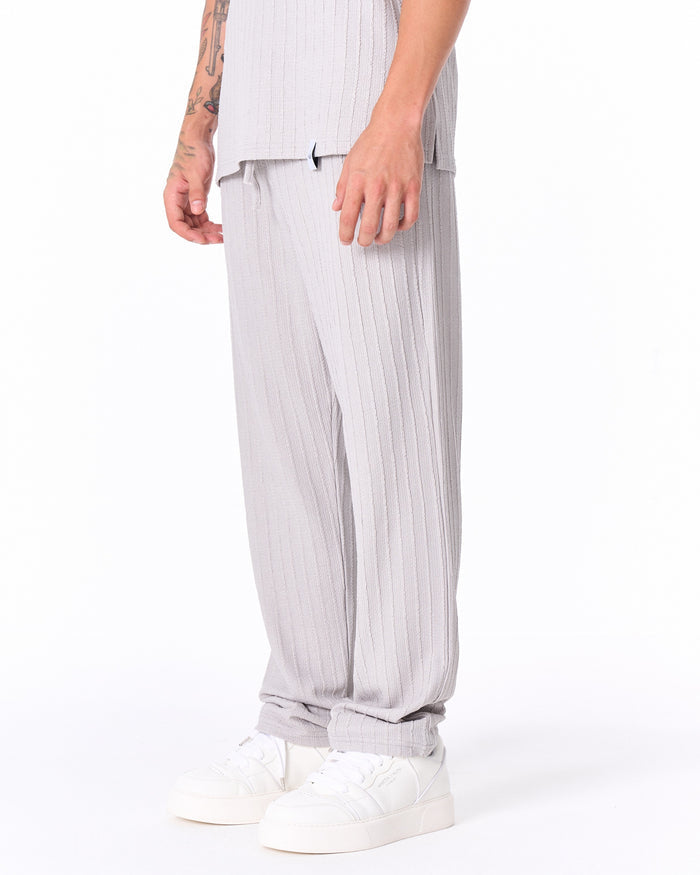 Full Martin Valen gray ribbed tracksuit side view, drawstring trousers and white sneakers visible at the hem
