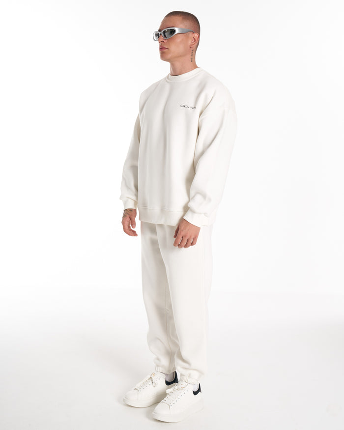 Martin Valen oversized white sweatshirt three-quarter view showing ribbed crewneck and small chest logo