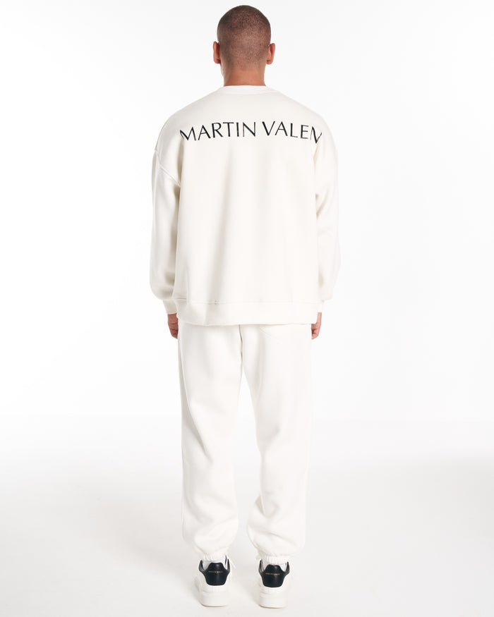 Martin Valen oversized white sweatshirt, rear view mid-body shot showing curved black logo across the upper back