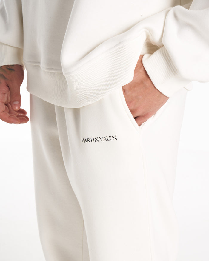 Martin Valen white tracksuit set, rear full-length view showing matching trousers and white sneakers with black heel brand detail
