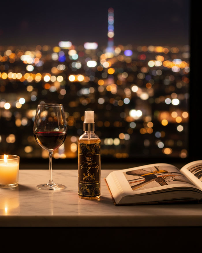 Eternia Noble Burgundy room spray bottle on a countertop with spray nozzle.