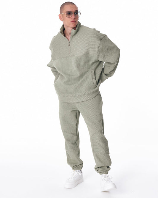 Martin Valen khaki high‑collar half‑zip tracksuit, three‑quarter view showing matching pants and relaxed fit