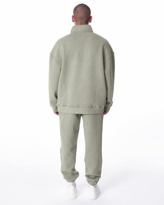 Martin Valen khaki high‑collar half‑zip tracksuit, rear view highlighting textured knit fabric