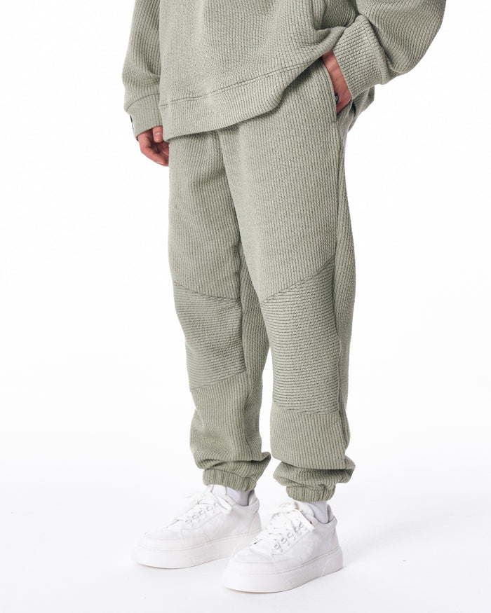 Martin Valen khaki high‑collar half‑zip tracksuit, side profile showing relaxed fit and ribbed texture