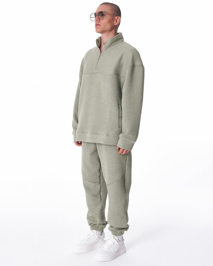 Martin Valen khaki high‑collar half‑zip tracksuit, three‑quarter left view showing textured knit and side pocket