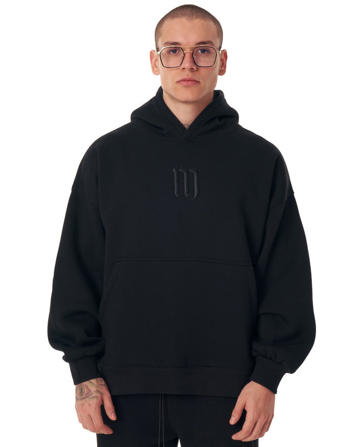 Martin Valen Insignio oversized black hoodie front view with 3D embroidered logo and raised hood