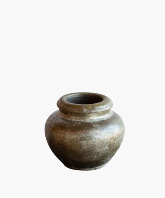 A rustic, weathered clay pot with a rounded body and a narrow opening, showcasing earthy tones and a textured surface, evoking a sense of antiquity. | Wildwood Home Co.