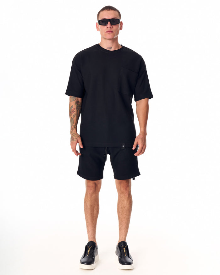 Martin Valen men's full black short tracksuit, front torso view showing oversized tee with chest pocket