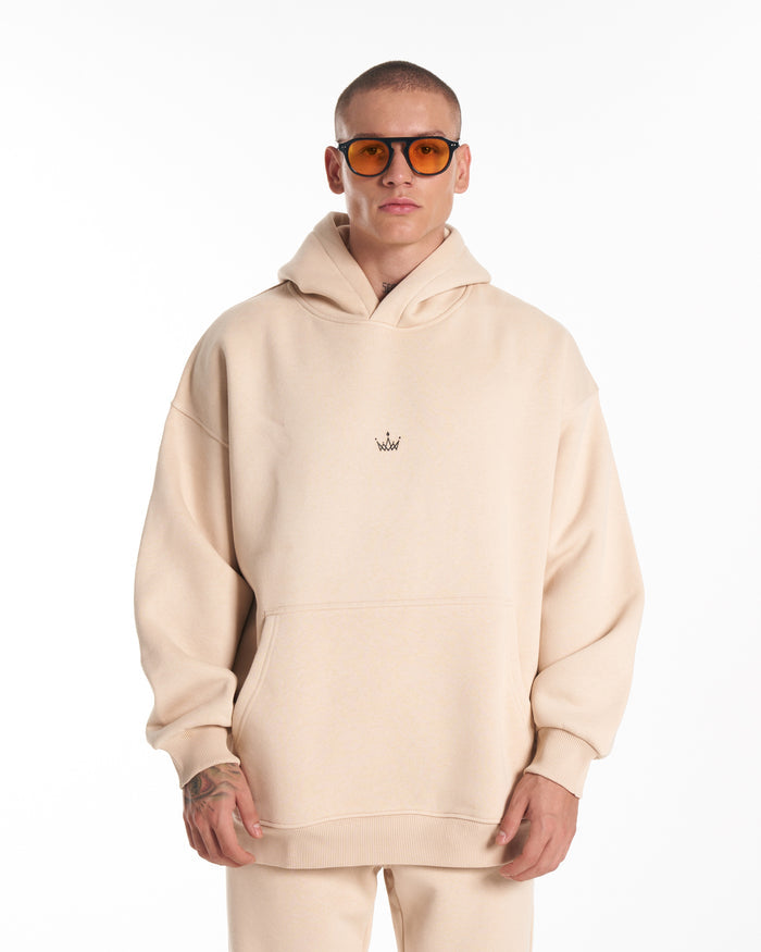 Martin Valen Regalia Crown beige tracksuit set, full-length view showing jogger pants and white sneakers while walking