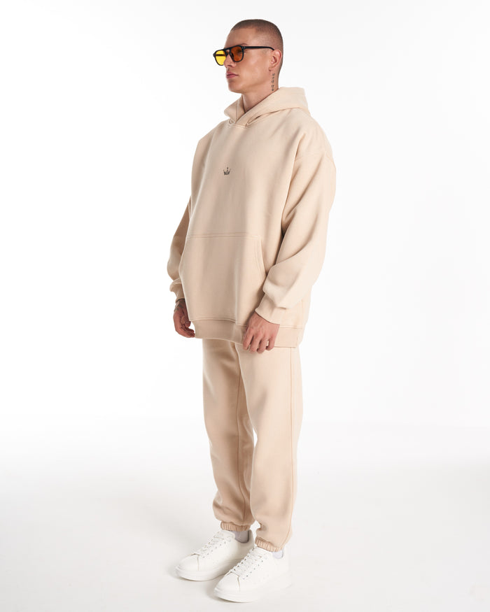 Martin Valen Regalia Crown oversized beige hoodie, side torso view showing small crown logo on chest