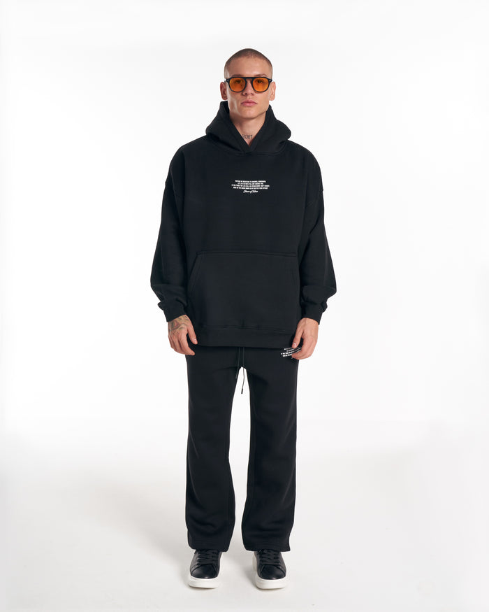 Martin Valen Rumi oversized black 3D-printed hoodie tracksuit, front view with white chest print and kangaroo pocket