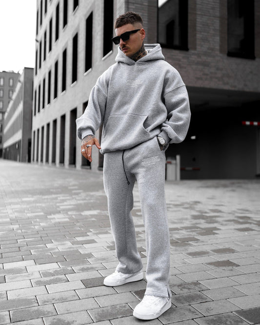Martin Valen Rumi oversized gray hoodie tracksuit, three-quarter front view showing small 3D printed chest text