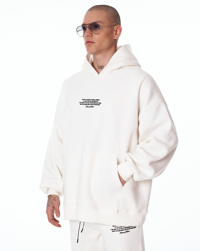 Martin Valen Rumi white sweatpants close‑up, black central drawstring and small printed text on the right thigh visible