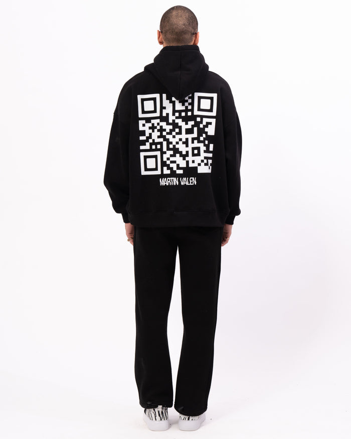 Martin Valen Sigilio oversized black hoodie with large white QR code on the back, rear view on model