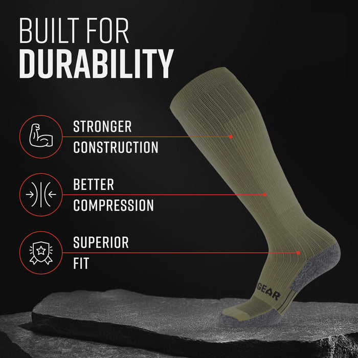 Olive drab green tall compression sock with gray heel and calf panel on dark stone