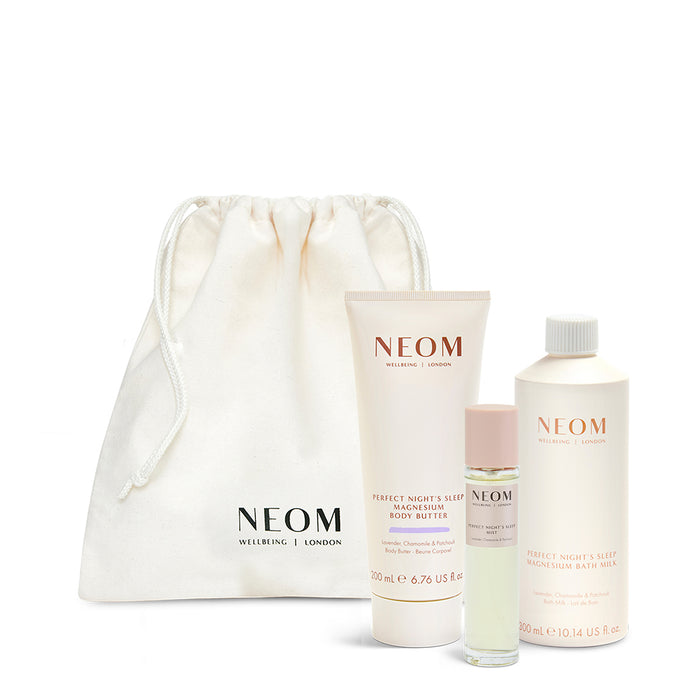 NEOM skincare products including a drawstring bag on a white background