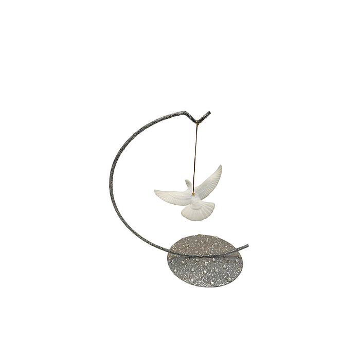 A decorative turtle dove ornament featuring a  white dove hanging from a dark curved metal frame with a round glittery base, isolated on a white background.